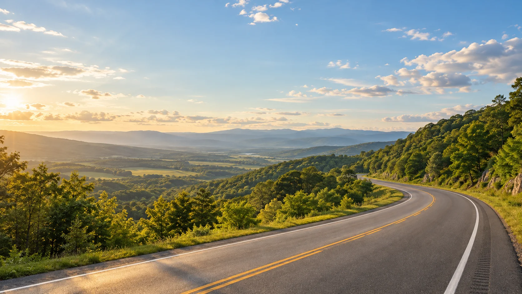 An open road winding through green hills toward the horizon